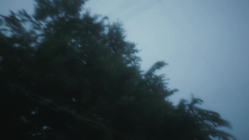 Someone drives a car through the rain