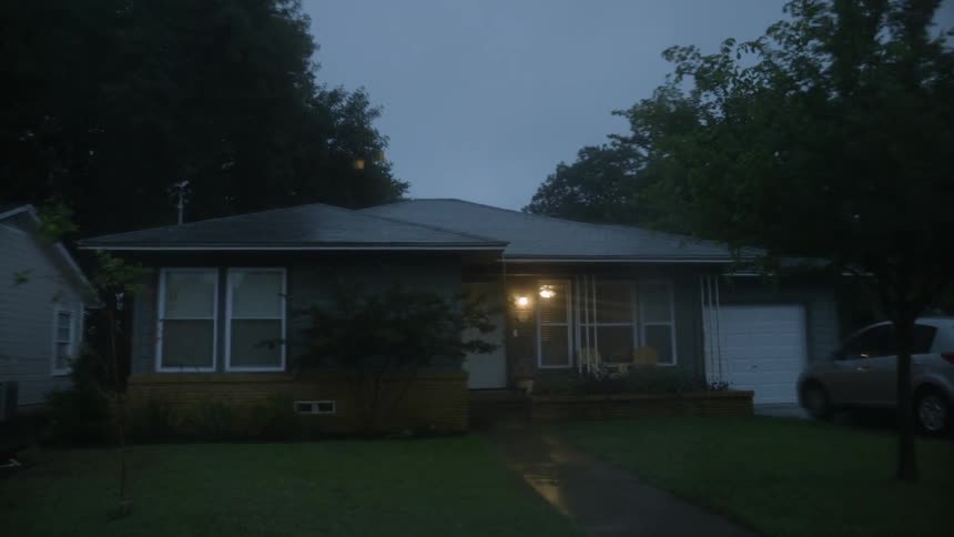A house surrounded by trees near dusk