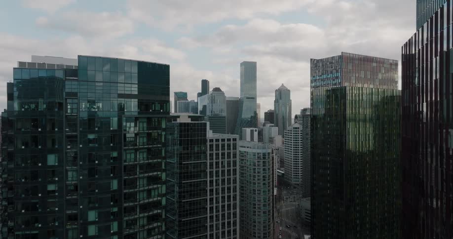 Ascending through an urban canyon to reveal the downtown core full of high rise buildings