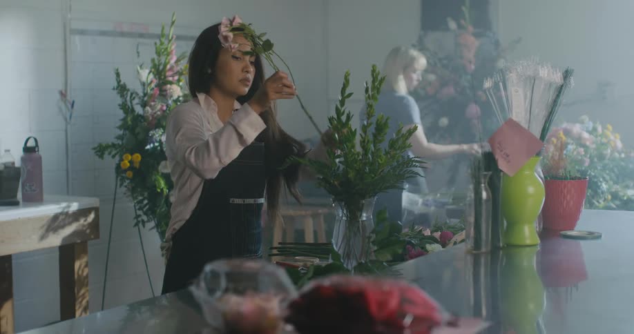 An employee is making bouquets in a store