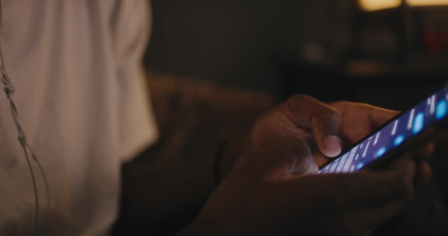Person holds phone and texts by typing with both hands