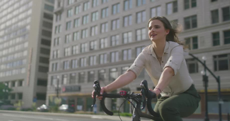 Woman cycles through intersection in downtown