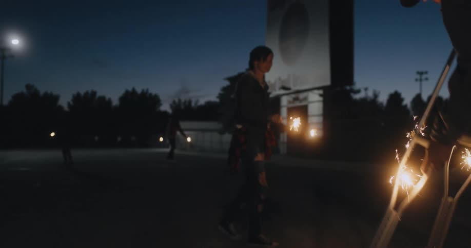 A group of people walking along with fireworks