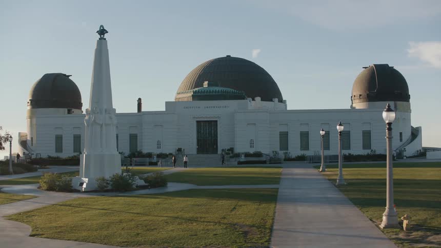 People stand on the steps of the domed building