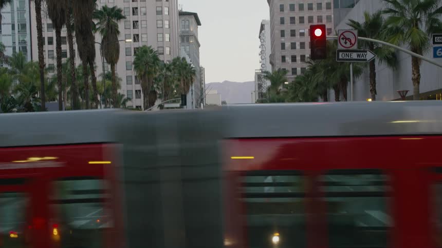 Female pedestrian crosses through crosswalk at intersection