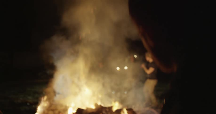 People are dancing around a fire