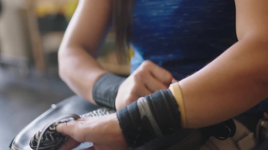 A woman wrapping her wrists