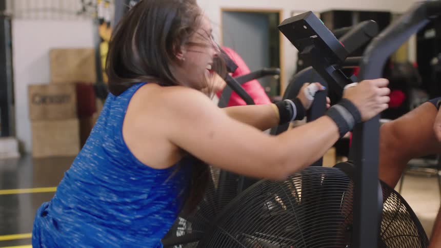 A woman is using the exercise equipment