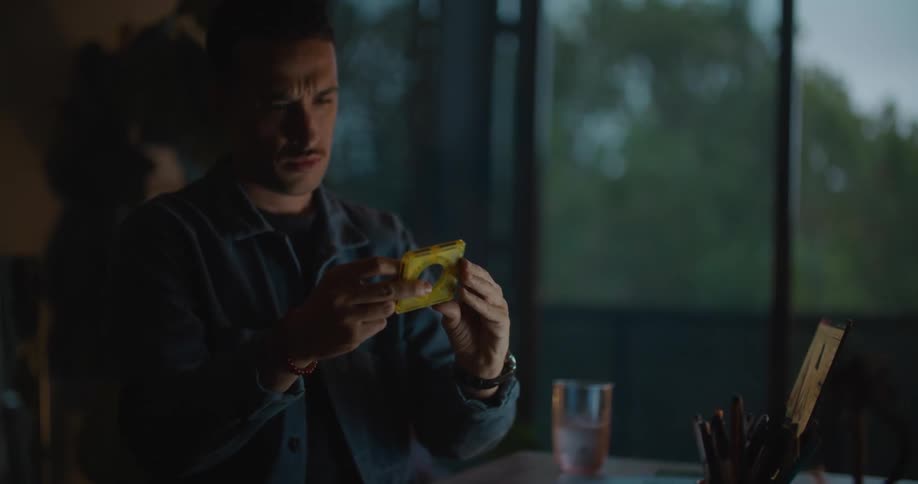 A man is writing down and thinking about something
