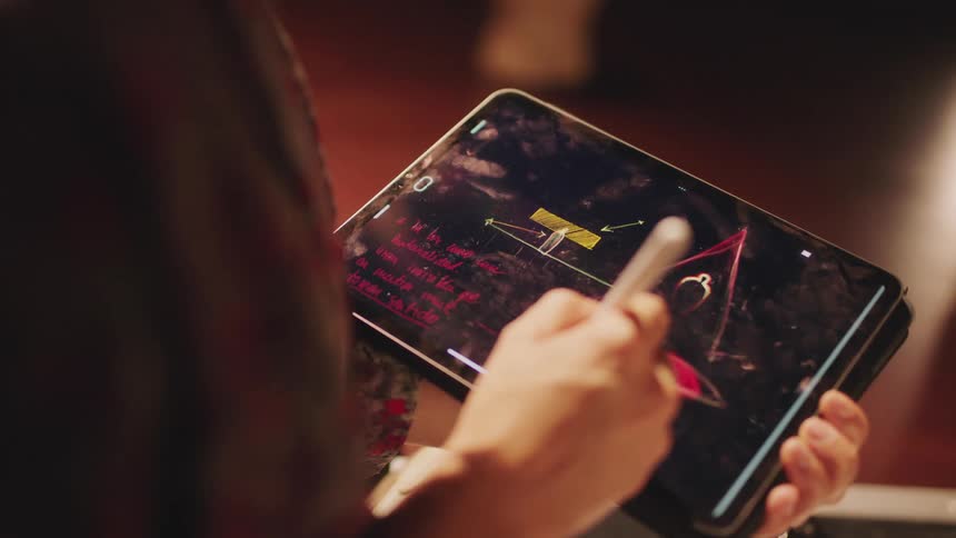Designer draws using a stylus on a touch screen tablet