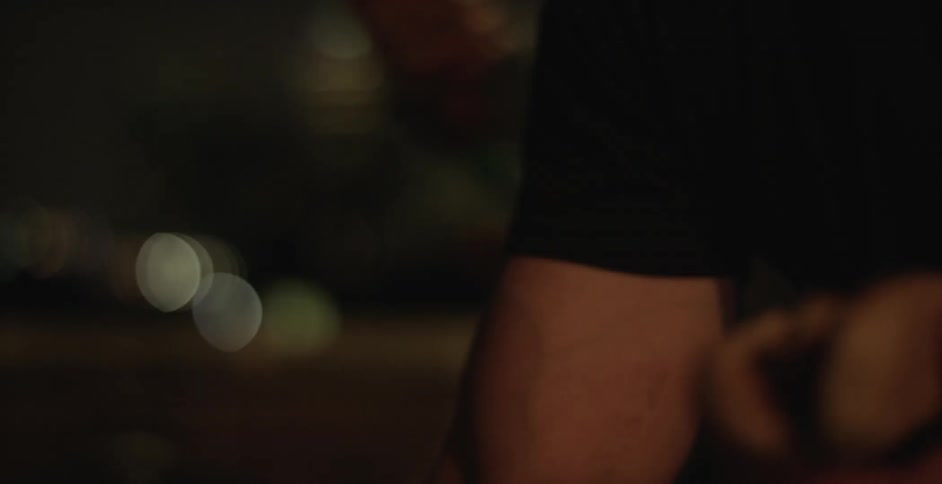 People prepare hot dogs at night