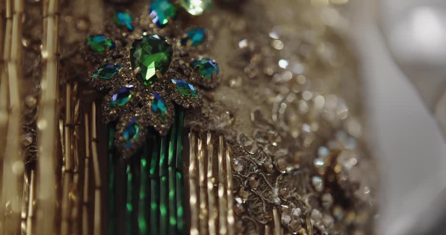 Beaded cloth and faceted jewelry hang as beaded strings sway slightly