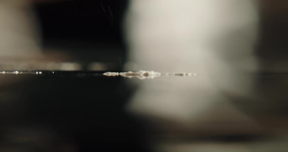 A person using a credit card to set up a line of cocaine