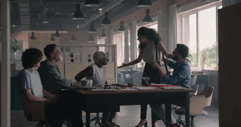 A group of businesspeople sits at desk and conducts a meeting in the office