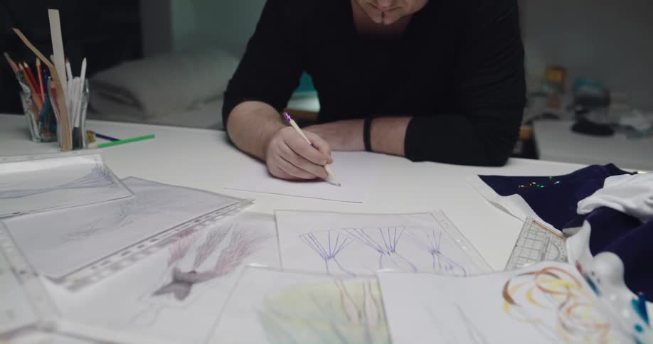 A man sketching clothes