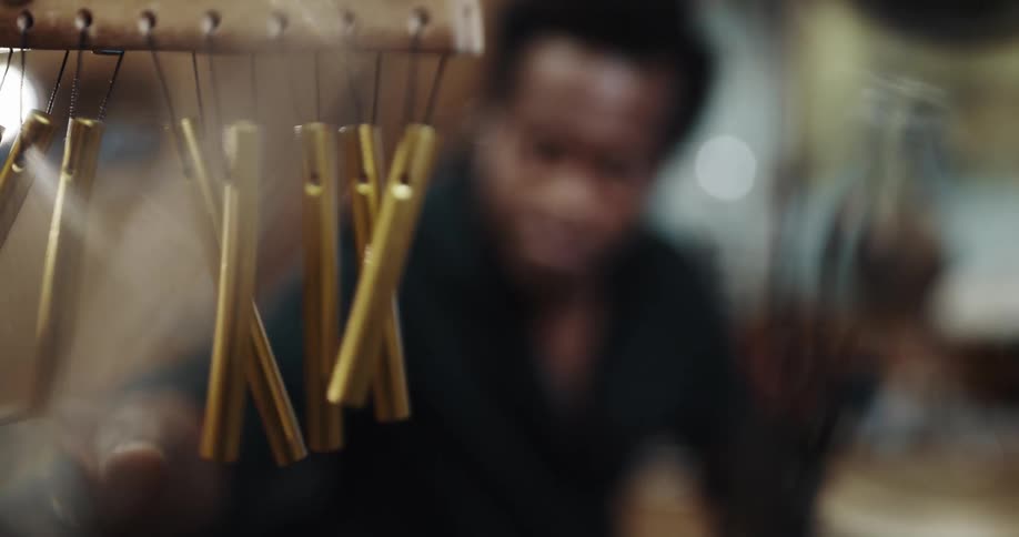 A man using chimes in a room