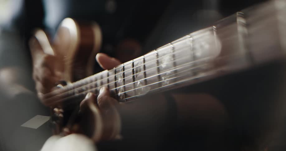 Close up of a man playing the guitar