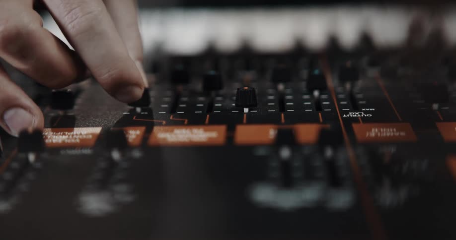 A person is playing the keyboards indoors