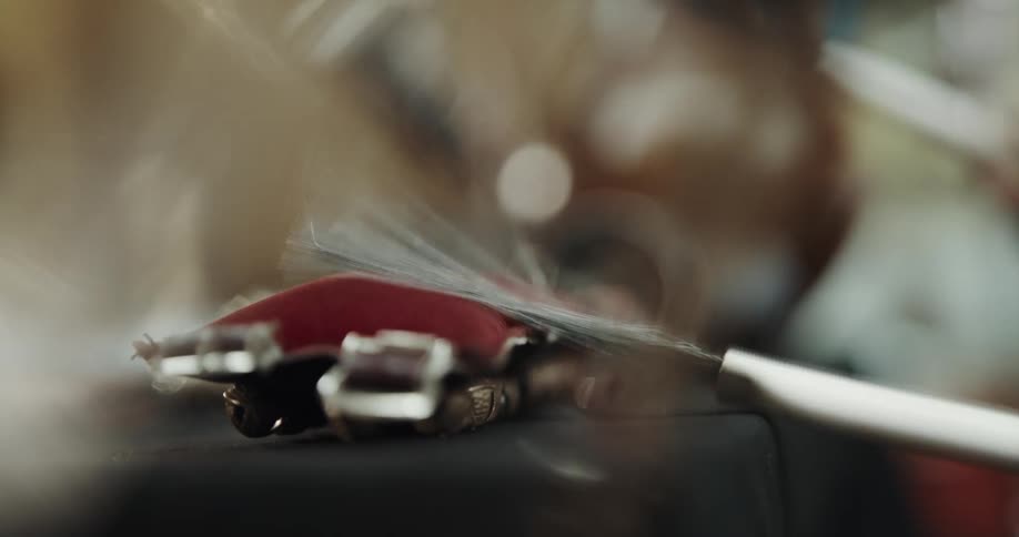 Man playing percussion with brushes metallic drumsticks over a cushioned musical instrument