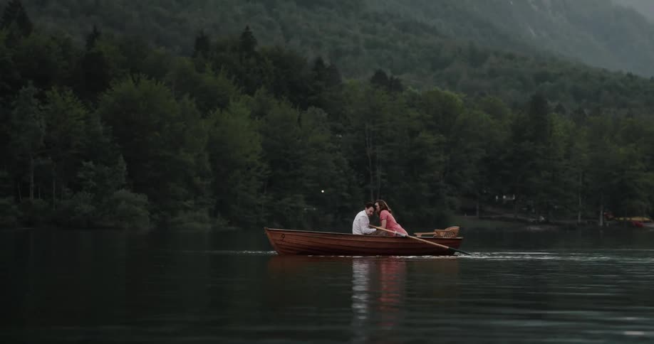 Man and woman are kissing on a boat during springtime