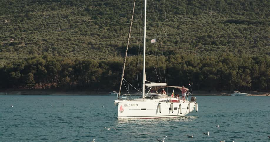 Two people are driving a boat on a lake during spring