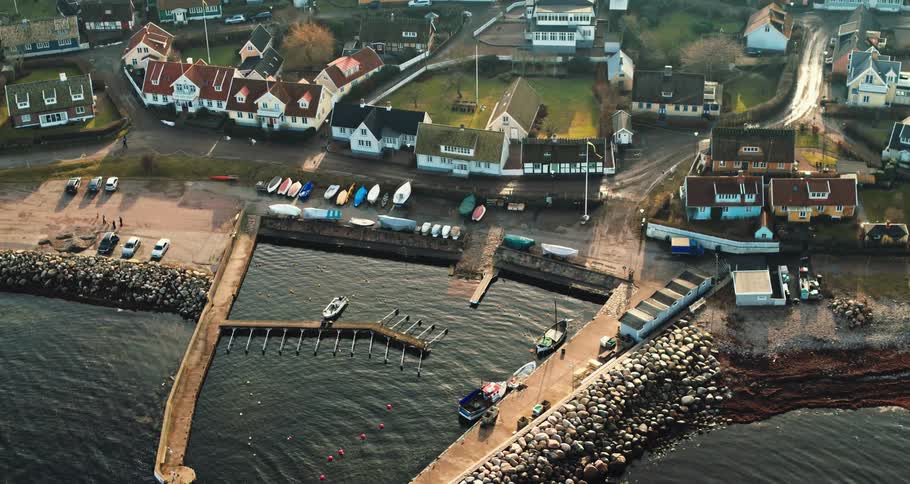 A waterfront village with stone jetty and boat docks