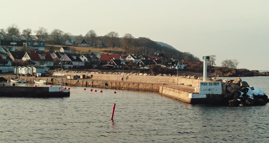 Ocean water flowing around the pier of a coastal community