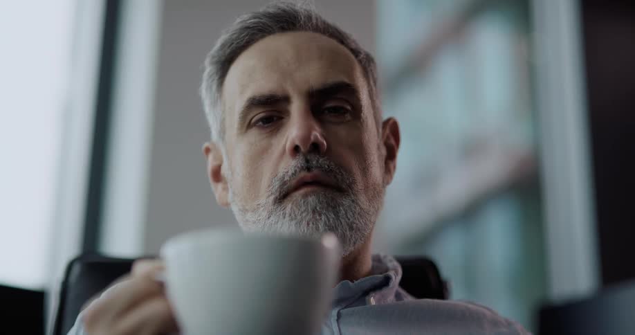 A man stirring a drink in a cup