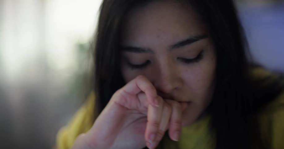 Young teenage woman concentrates while working or studying at home