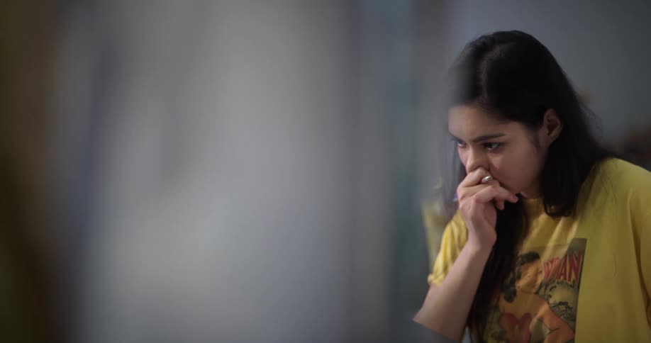 Young teenage woman concentrates while working or studying at home