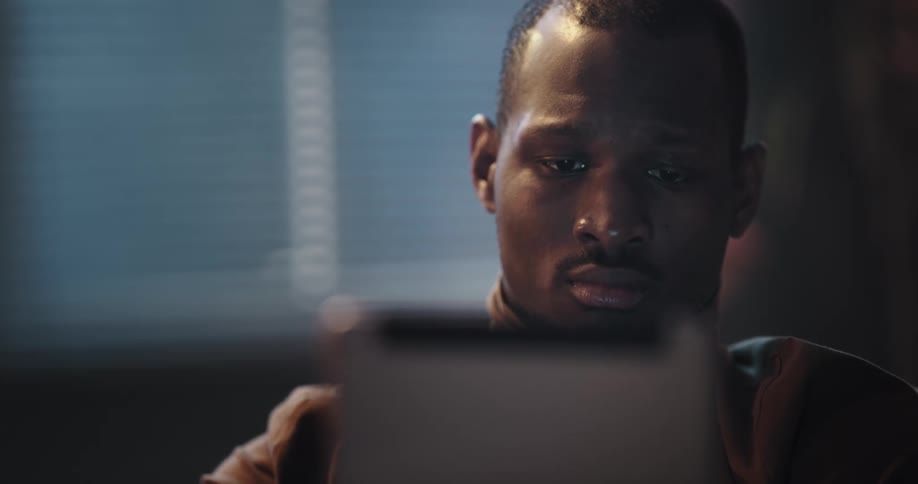 Black man using his tablet to purchase something with his credit card