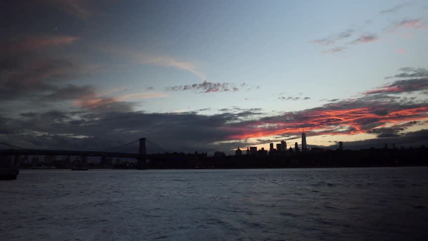 The sun sets on the city in the distance