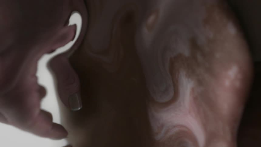 The hand of a person is distorted warped and swirling due to digital effects