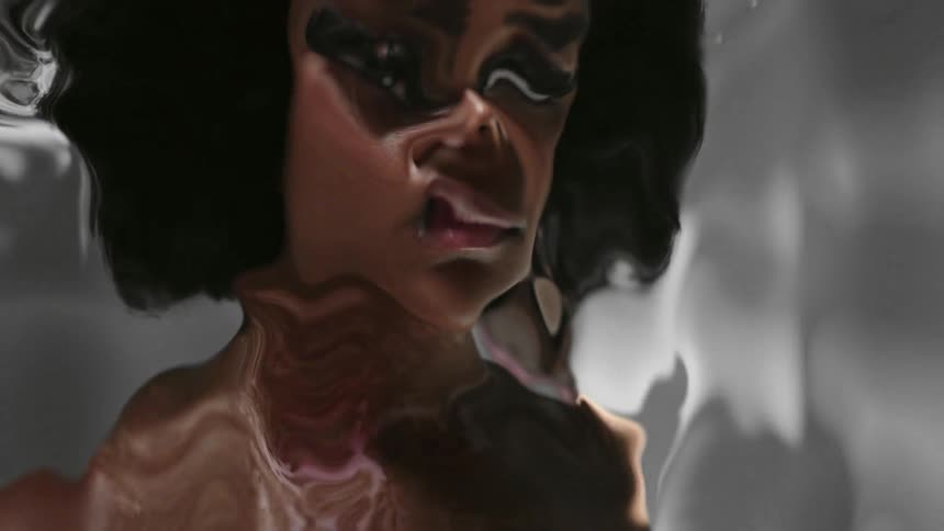 A womans face and head are heavily distorted by special effects