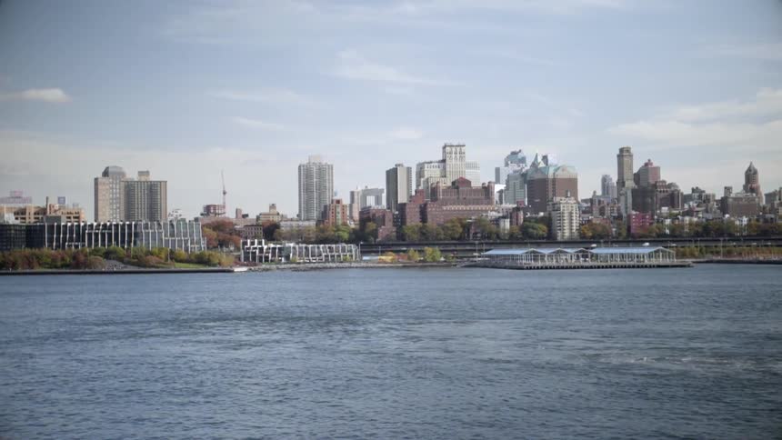 Moving across a river with a city in the distance