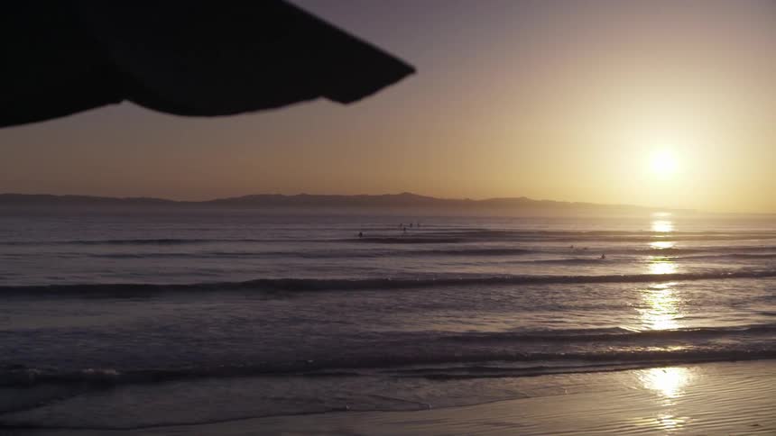 The sun is setting over the beach