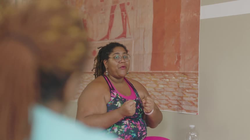 A woman smiles as she excitedly talks to a friend