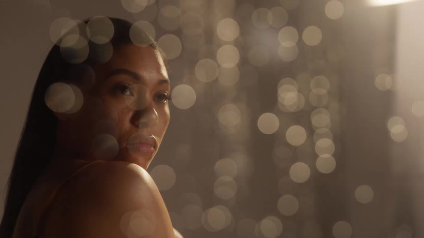 Model looking through a wet window with water drops running down
