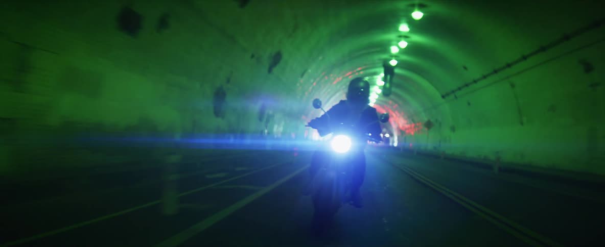 Motorcycle rider driving through a tunnel in the city