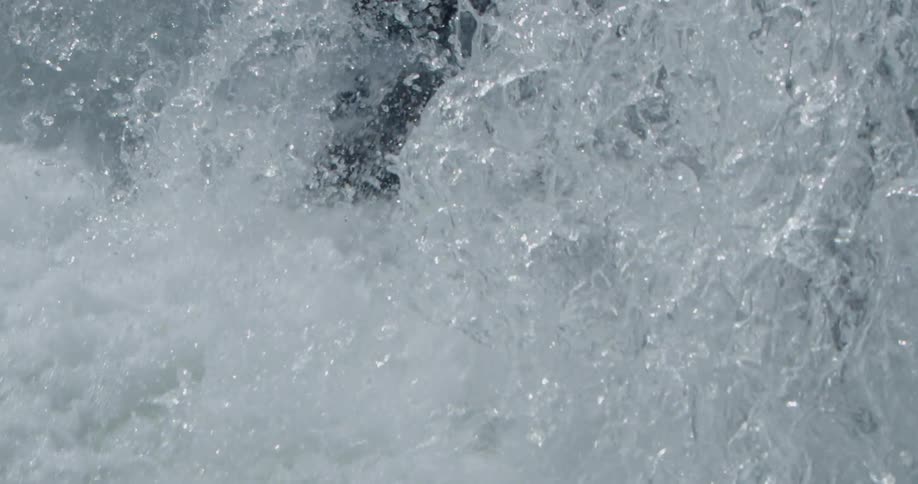 Falling water crashes down in the daylight