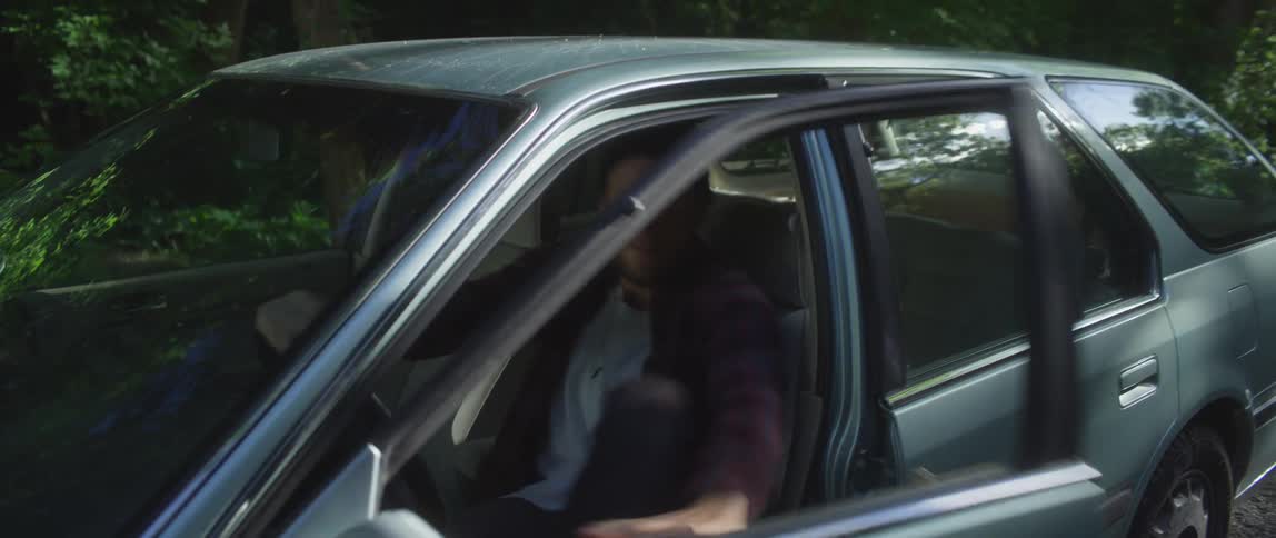 Man angrilyhits steering wheel when car stalled on side of dirt road cannot start then he gets out and runs