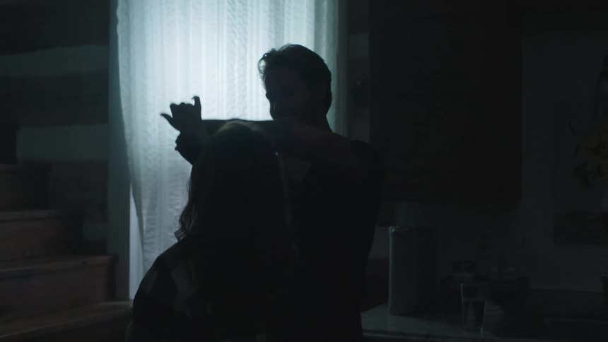 Couple happily dancing together inside the house