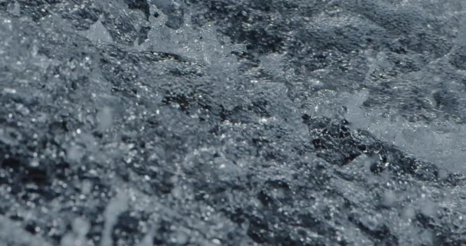 Turbulent water splashes and foams as it falls through the air