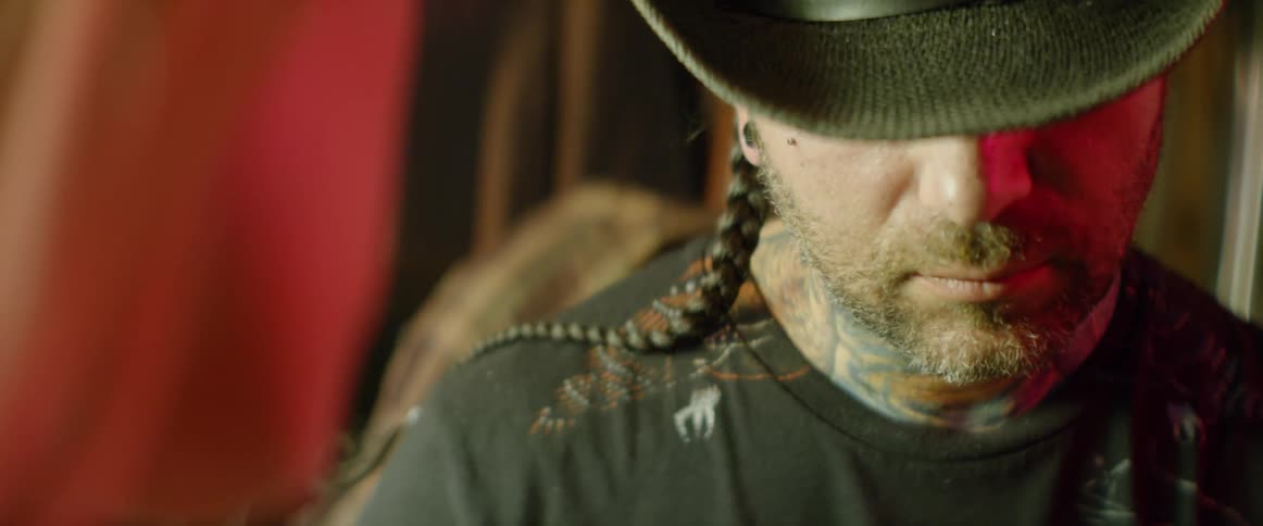 Close up of a man wearing a cowboy hat