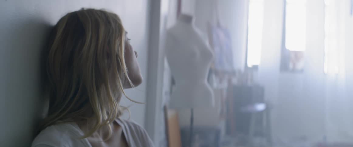 A woman turns towards a mannequin
