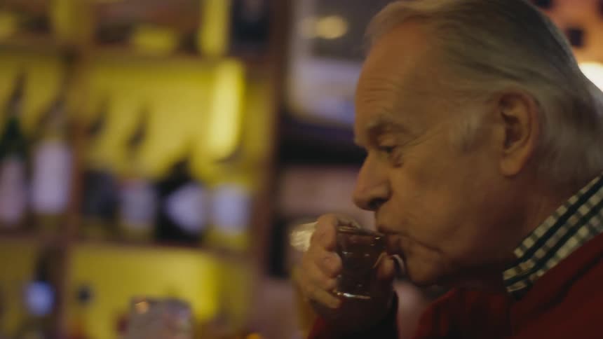 Man and woman are drinking alcohol together at a bar