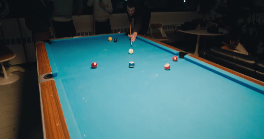 A group of friends are playing a game of pool together