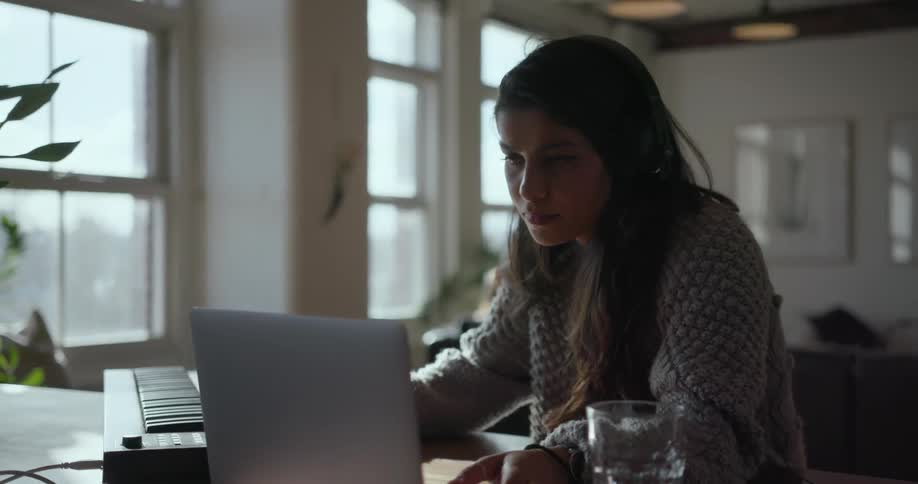 Girl sits at table listening to music