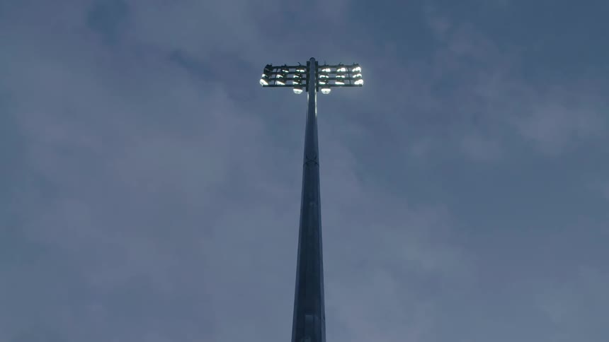 A light post is shown tall in the sky