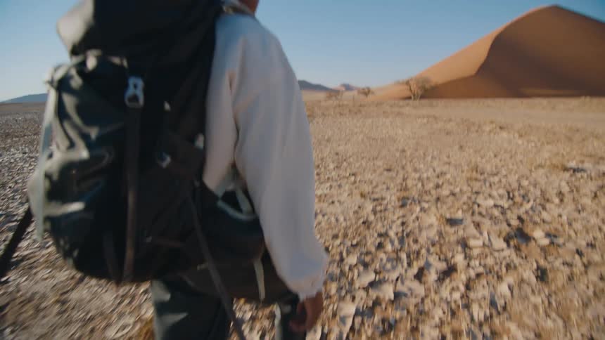 Black woman backpacking in the desert